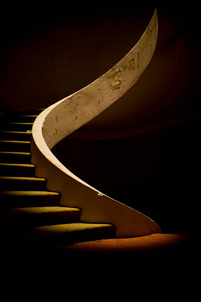 Spiral staircase in dramatic light stock photo