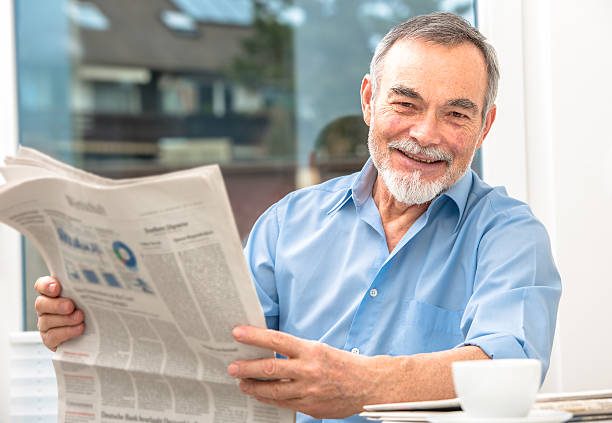 istock Senior man reading newspaper and drinking coffee 467440299