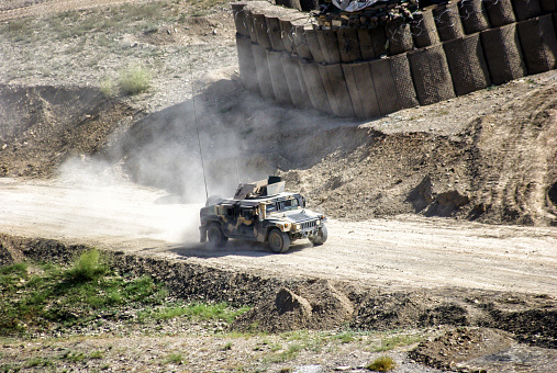 Kaboul, Afghanistan - August 20, 2010:  A vehicle type humvee, of American army origin was recovered by the Afghan army,with a green camouflage it goes at full speed towards the south, August 2010