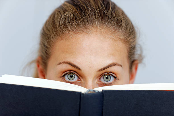 istock Woman holding a book up 467441035