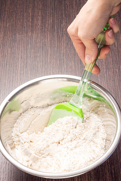 istock Mixing wheat flour in metallic bowl 467443939