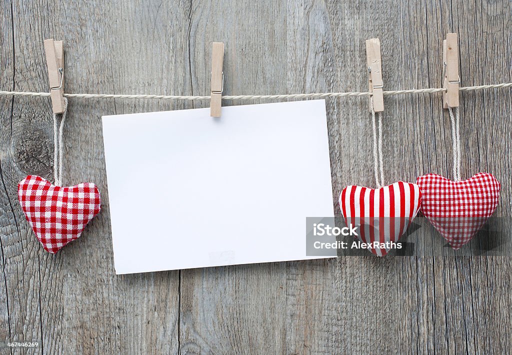 Message and red hearts on the clothesline Message and red hearts on the clothesline against wooden background Celebration Stock Photo