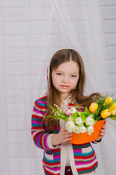 istock Little girl with spring flowers 467447410