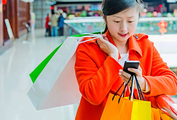 istock female shopper texting on mobile phone 467447790