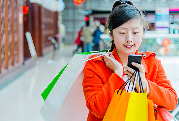 istock female shopper texting on mobile phone 467447792