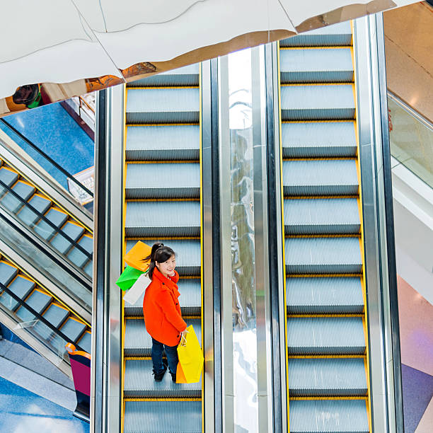 istock Female shopper standing on escalator 467447832