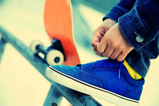 istock skateboarder tying  shoelace 467447954