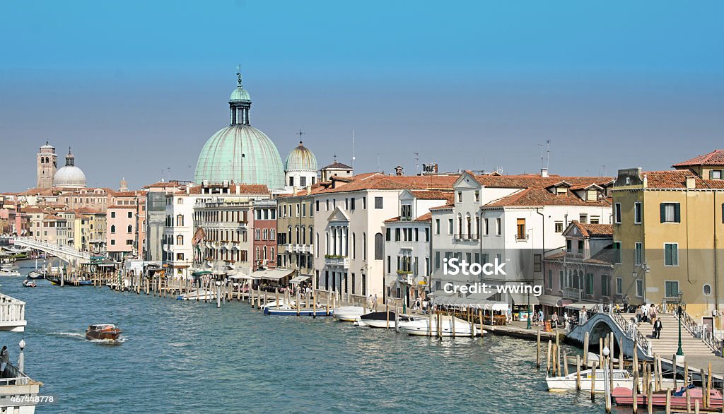 Venice Grand Canal showing palaces, homes,boats,taxi. Venice Grand Canal showing palaces, homes,boats,taxi. From a bridge. 2015 Stock Photo