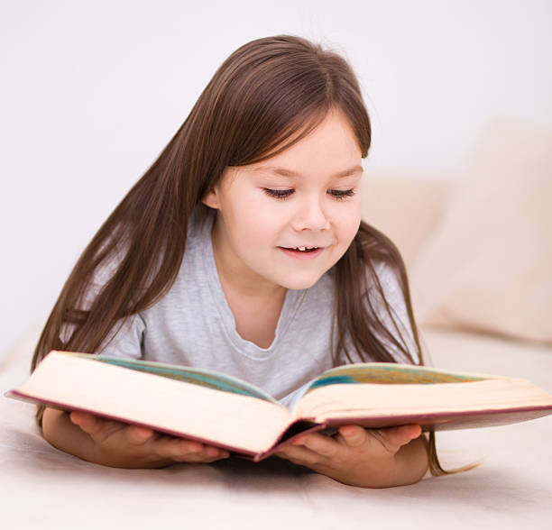 istock Little girl is reading a book 467449031