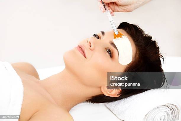 Beautiful Woman Getting Spa Treatment Cosmetic Mask On Face Stock Photo - Download Image Now