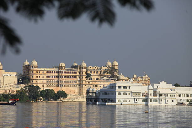 View of the Lake Palace and City Palace, Udaipur An image looking across Udaipur's Lake Pichola towards the beautiful Lake Palace and City Palace behind, both are situated in India's Rajasthan state  lake palace stock pictures, royalty-free photos & images