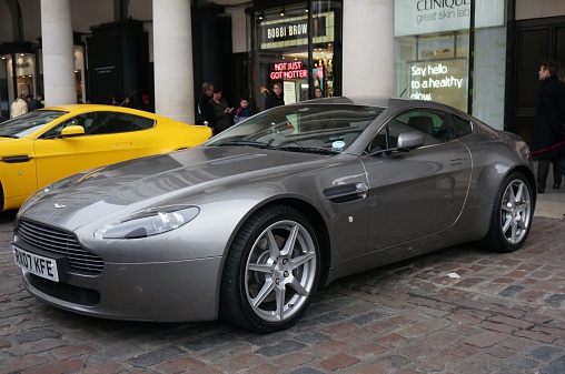London, United Kingdom, 21st March 2015: an Aston Martin car on display in Covent Garden piazza, with shops and passers-by in the background 