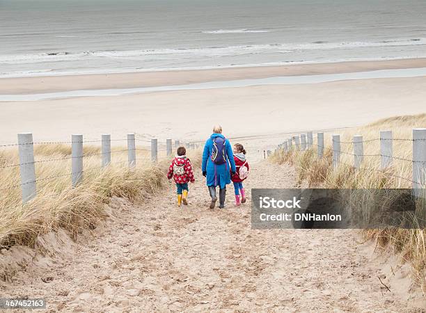 Woman And Two Small Children Walking Down To The Beach Stock Photo - Download Image Now