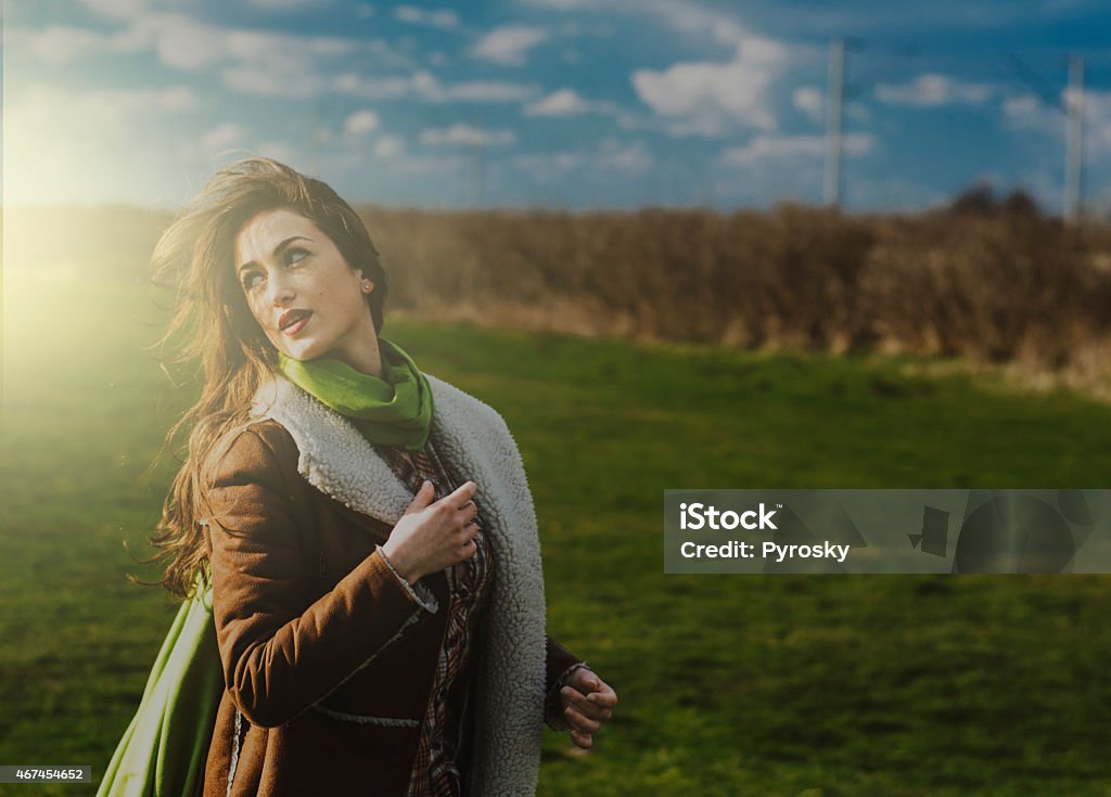Beautiful girl outdoor stock Beautiful girl on a fild looking behind her shoulder. 20-29 Years Stock Photo