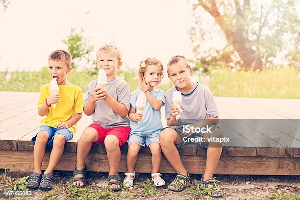 Four Happy Young Children Are Enjoying Icecream Cones Stock Photo - Download Image Now