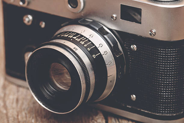 istock Vintage camera on wooden background 467455164