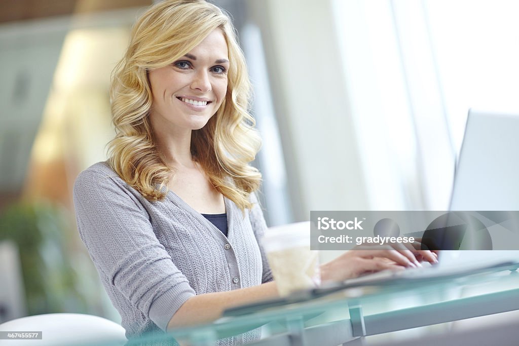 She's motivated to succeed! An attractive businesswoman working on her laptop during her morning coffee 30-34 Years Stock Photo
