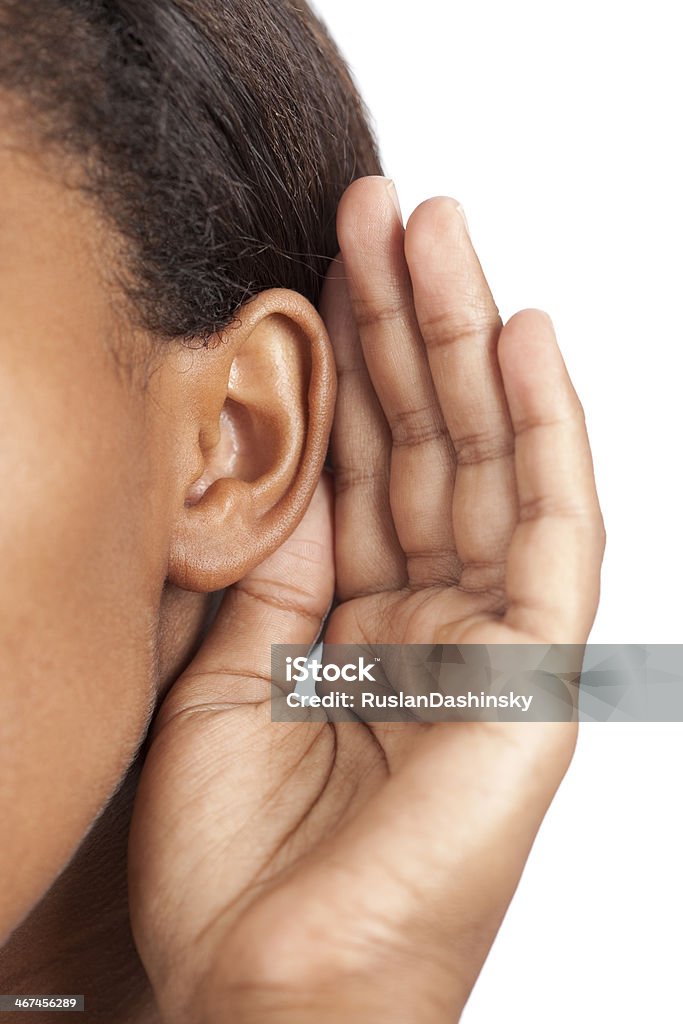 Listening. Close up on unrecognized woman listening. Listening Stock Photo