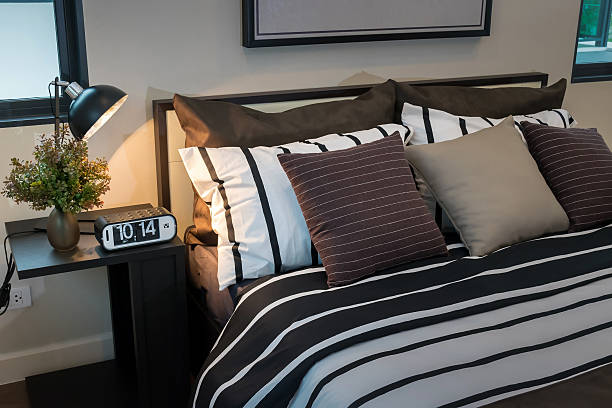 istock modern bedroom with brown, black and white striped pillows 467456324