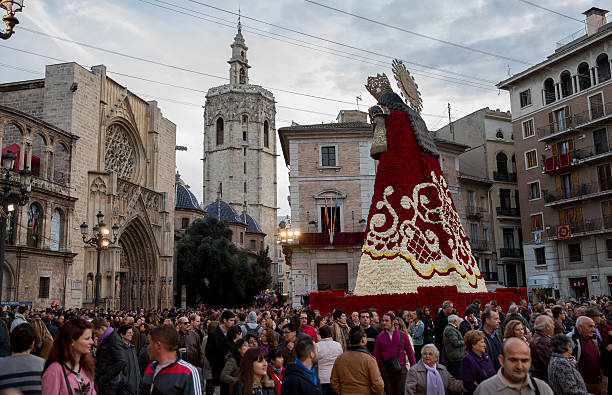 Valencia, Spain – March, 19, 2013: Flower offering to Virgin Mary in Fallas festival. They dress the Virgin Mary with flowers in the Cathedral's square for two days, every year in the celebration of Fallas. After that, people visit te Virgin Mary.