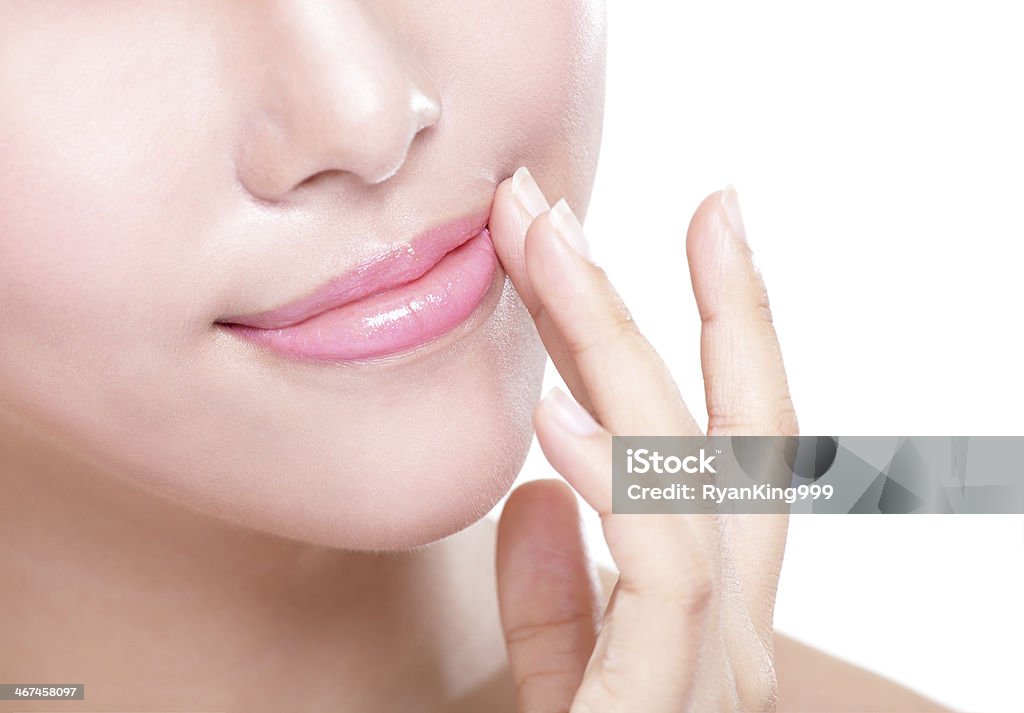 young woman with beautiful lips Close up portrait of young woman with beautiful lips isolated on white, asian beauty Adult Stock Photo