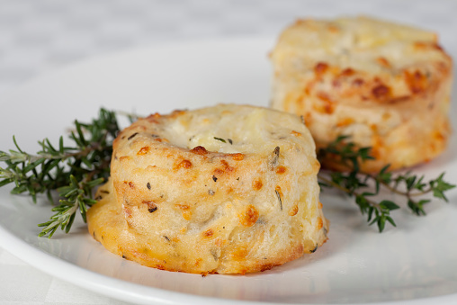Side dish of potato souffle with rosemary and thyme.