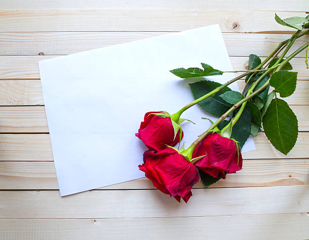 istock Red roses on a wooden table 467460886