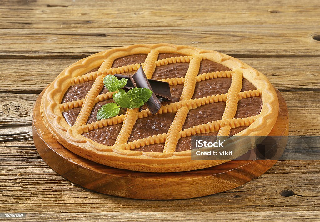 Chocolate tart Lattice topped chocolate tart on wooden cutting board Torte Stock Photo