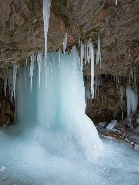 istock Large ice pillar stands in a cave 467462765