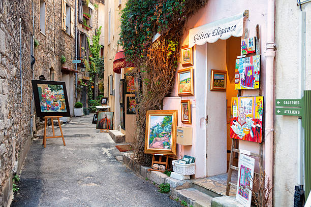 Mourns, France - April 25, 2010: Art galleries line the Rue d'Orfevres in the Provence Village of Mougins located near the Mediterranean Sea.  The mild climate has made this village a popular destination for artists worldwide.  The pedestrian street curves its way through the village, and is lined with workshops and galleries.  Picasso made his home in Mougins for years, and drew many artists there.