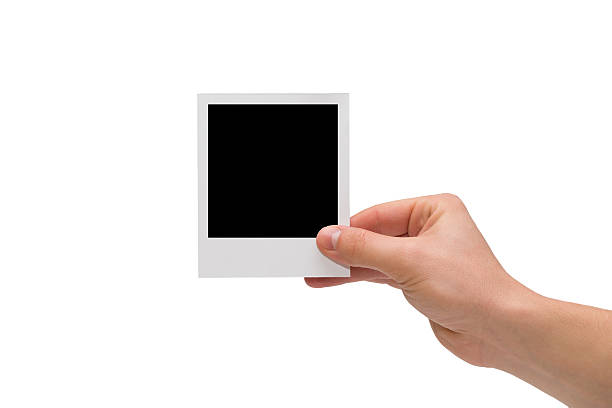 istock Hand holding blank instant photo 467463577