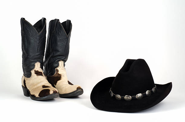 istock Cow Hide Cowboy Boots and Hat with Concho Hatband. 467463667