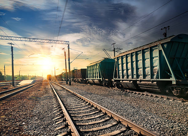istock Green train and railroad tracks leading to dramatic sunset 467463721