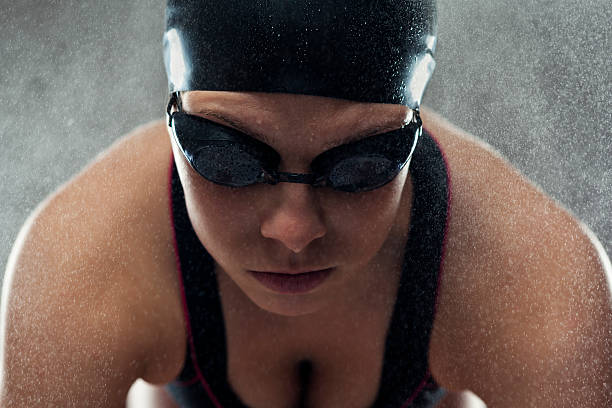 istock Female professional swimmergetting ready for jump 467464057