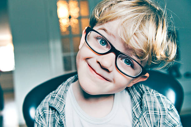 istock Boy with big black glasses makes a funny smiling face 467464400