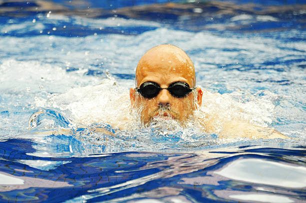 istock Young professional bald swimmer swimming in swimming pool 467466622