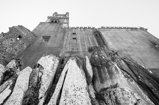 Sintra, Portugal - July 16, 2012: Detail of castle with clock tower built on cliffs at Pena National Palace (Palácio Nacional da Pena) in Sintra, Portugal - since 1995 classified as a World Heritage Site by UNESCO.