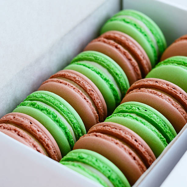 istock Set of pistachio and caramel macaroon in white box, square 467466792