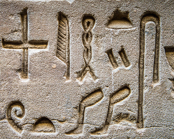 Painted Egyptian Hieroglyphs on the walls of the tomb of the Pharoah Rameses IV at the archaeological site in the Valley of Kings.