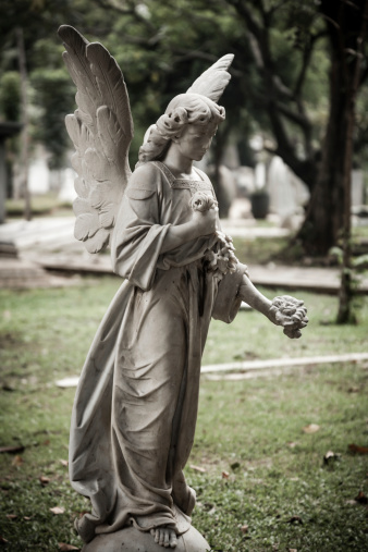 Jakarta, Indonesia - January 11, 2014: Statue of angel in old cemetery Museum Prasasti