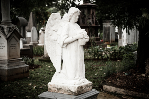 Jakarta, Indonesia - January 11, 2014: Statue of Angel in old cemetery Museum Prasasti