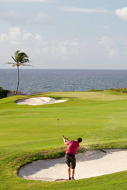 istock Senior Golfer Hitting Bunker Shot on Tropical Golf Course 467469935
