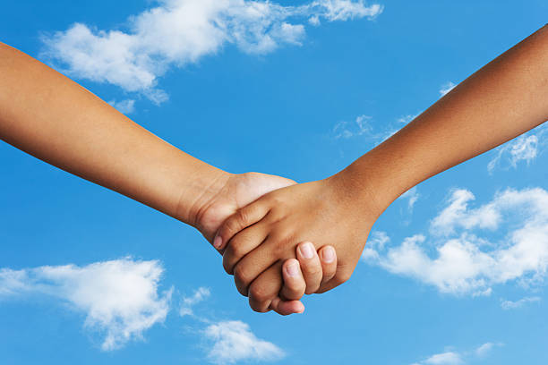 istock Couple holding hands sky background 467470642
