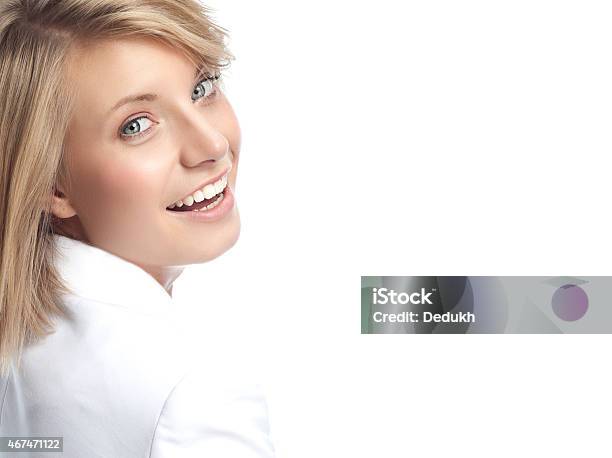A Woman Looking Over Her Shoulder And Smiling At The Camera Stock Photo - Download Image Now