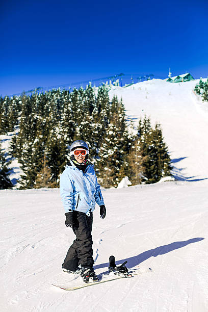 Female Snowboarder learning stock photo