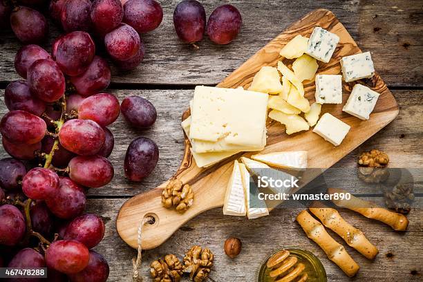 Emmental Camembert Cheese Blue Cheese Bread Sticks Nuts Honey Grapes Stock Photo - Download Image Now