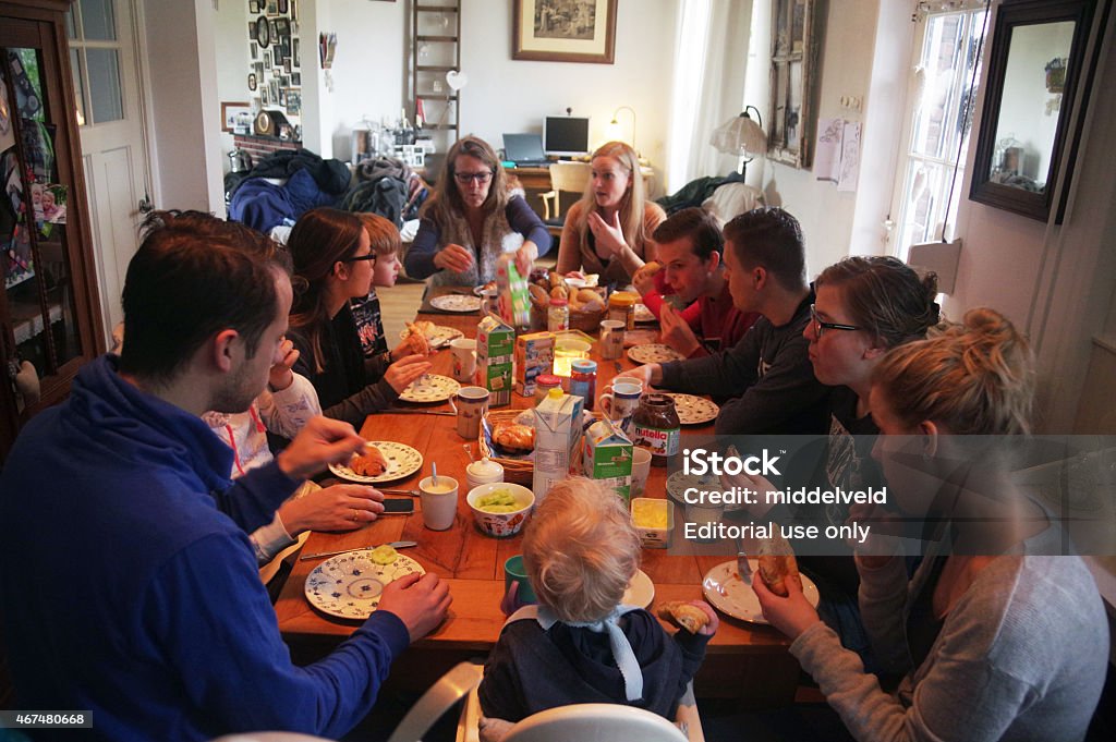 Family brunch Brunssum, the Netherlands - March 21, 2015. Family sitting at a big table and having a brunch party in the morning. As you can see they enjoy this event and the food was delicious. Large Family Stock Photo