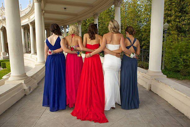 Group of Girls in Prom Dresses Rear View A group of five girls in their prom dresses viewed from the rear.  Photo taken at the Organ Pavilion in San Diego's Balboa Park prom photos stock pictures, royalty-free photos & images