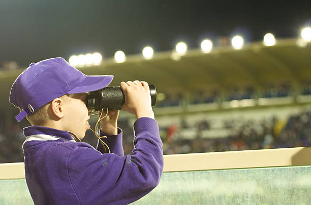 istock young fan follows the action with binoculars 467486134