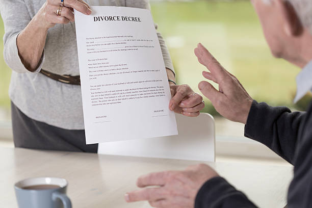 istock Female hands holding divorce paper 467488858